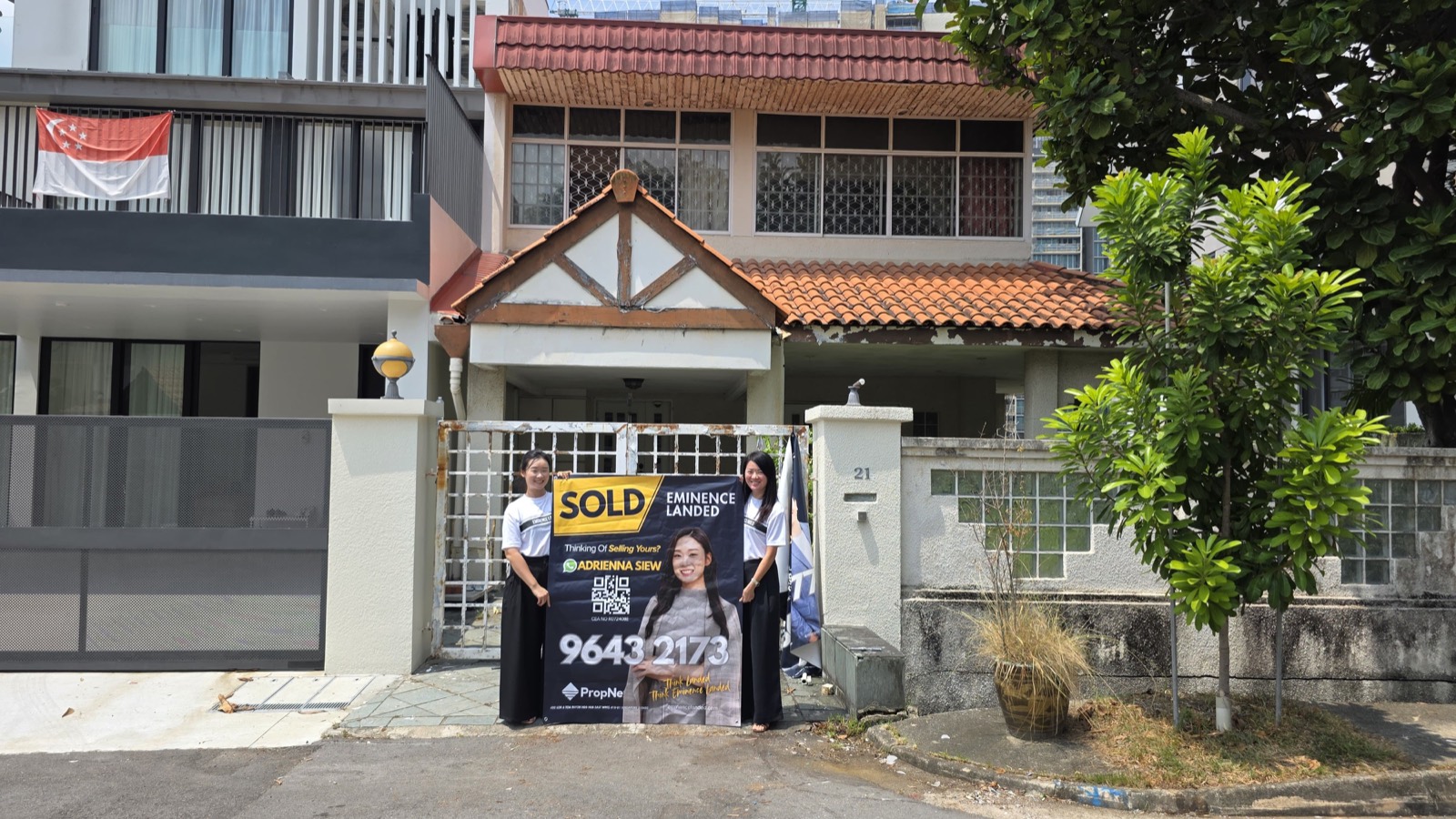 Adrienna Siew and the Eminence Landed team holding a SOLD banner outside a Singapore terrace house